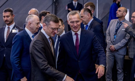 NATO Secretary General Jens Stoltenberg (C-R) shows Ukrainian Foreign Minister Dmytro Kuleba (C-L) where his chair is before the start of the NATO-Ukraine Council meeting on the second day of the NATO Foreign Ministers’ meeting.