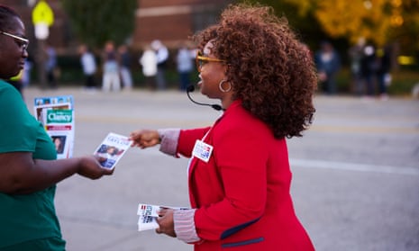 Shalira Taylor, Republican candidate for State Representative House District 18, passes out flyers to voters on their way to the polls during early voting yesterday in Cleveland, Ohio.