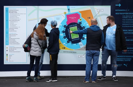 Some Manchester City fans get their bearings at the Etihad Campus.
