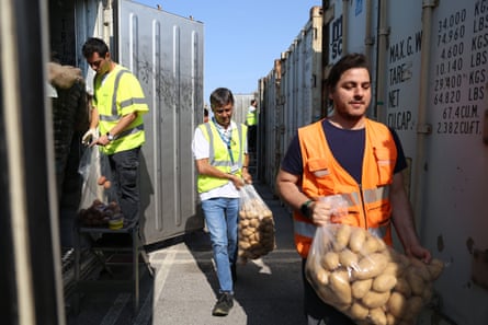 Paolo Solmi, centre, and his team with bags of potatoes among the containers at Ravenna port.