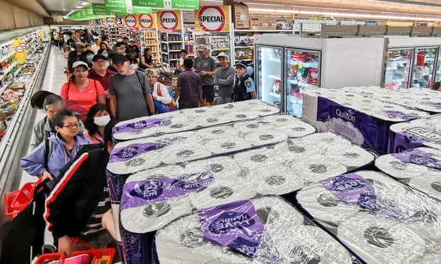 People queue to buy toilet paper, paper towels, pasta and other goods at Coles in Epping