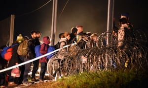 Migrants arriving from Croatia cross the border to Hungary before it was sealed with barbed wire early on Saturday. 