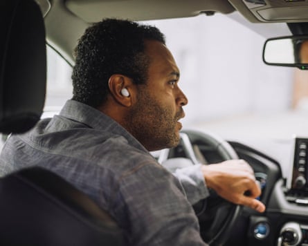 A man driving a taxi.