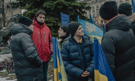 Andrii Semeniuta, 19, (red jacket) at the memorial to fallen defenders of Ukraine in Maidan the day after Zelensky met Trump in Washington