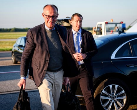 German chancellor Friedrich Merz, left, walks to the Air Force Airbus A319 at Franz-Josef-Strauss Airport in Munich for the flight to Washington.