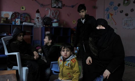 Residents sit inside a school turned into a shelter in Aleppo, Syria.