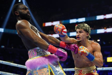 Jaron ‘Boots’ Ennis (left) evades a punch from Xander Zayas (right) during Saturday’s unified 154lb title bout.