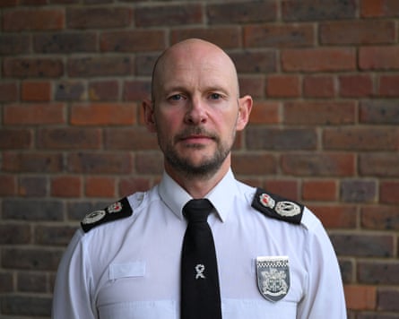 Chief constable Jason Hogg standing in police uniform in front of a brick wall