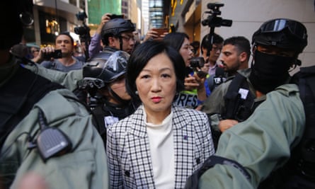 Regina Ip is escorted by police while surrounded by pro-democracy protesters during a rally in November 2019.