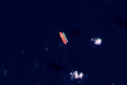 Tankers suspected of carrying sanctioned oil are seen performing a transfer in the South China Sea.