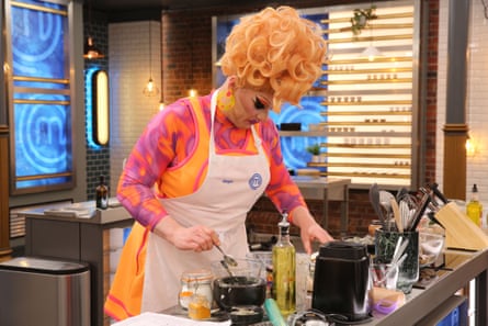 Ginger Johnson with huge red-blond wig and elaborate makeup, in the MasterChef kitchen