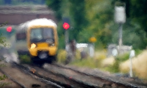 A train passes through heat haze on a railway line near Ashford in Kent. 
