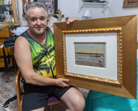 Andres Hurtado displays a painting by Spanish artist Joaquin Sorolla at his home in Puebla de Soto, Murcia, Spain