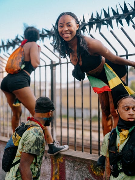 A smiling young woman leaning out from railings