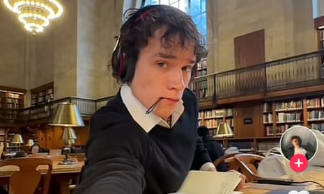 man in headphones and collared shirt and sweater at table in tiktok screen shot