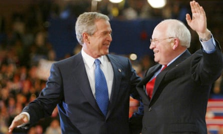 George W Bush and Cheney embrace on stage, as Cheney waves