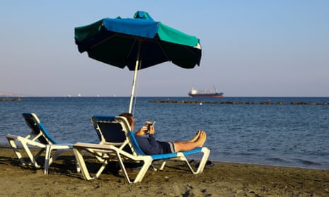 A tourist on a beach in Limassol. British visitors are the largest market for the island’s tourism industry. 