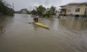 Graham Crighton kayaks in floodwaters in Hermit Park, Townsville