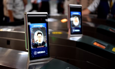 A man passes the ticket gate through facial recognition payment system at Zijingshan