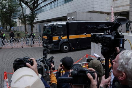A prison van believed to be carrying Jimmy Lai leaves the West Kowloon magistrates courts building in Hong Kong after sentencing