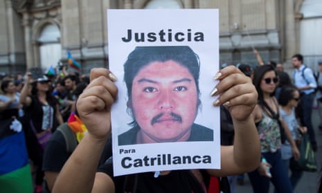 A demonstrator holds a banner picturing a portrait of late Mapuche community member Camilo Catrillanca on the first anniversary of his murder, in Santiago, Chile.