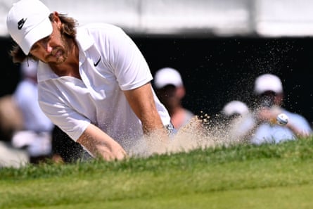 Tommy Fleetwood hits out of a bunker on the first hole during the final round of the Travelers Championship.