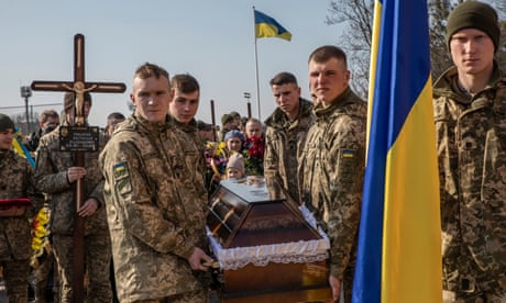 People gather for the funeral of military servicemen in Lviv, Ukraine, on Tuesday.