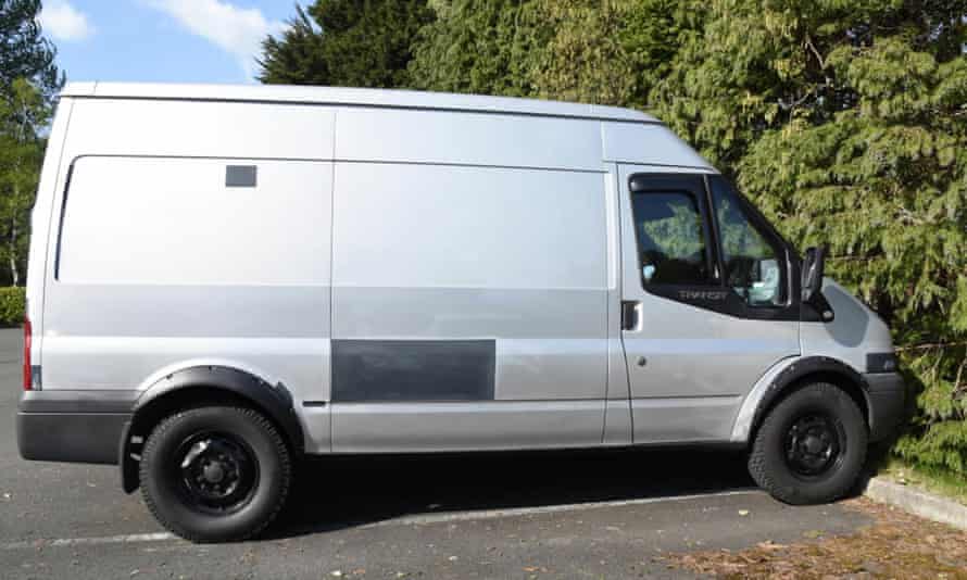 The silver Ford Transit parked in a car park.