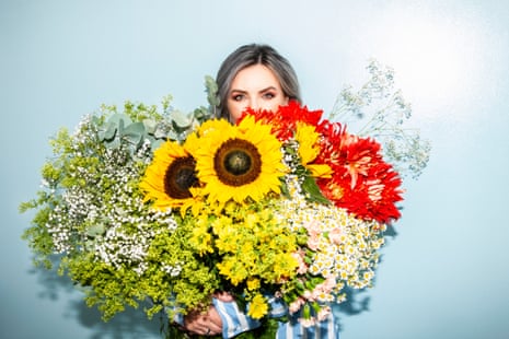 Sali Hughes almost hidden behind an enormous bunch of flowers