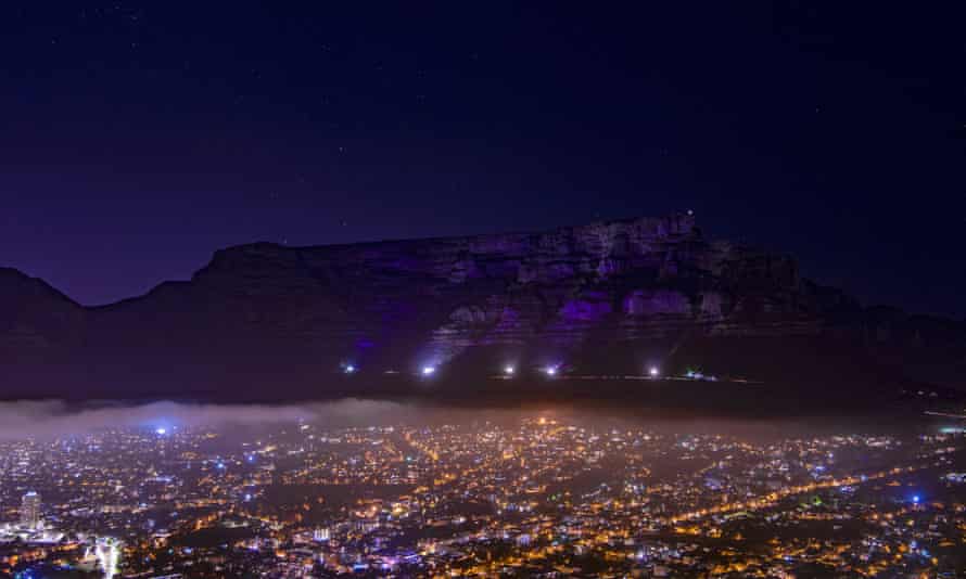 Table Mountain in Cape Town, South Africa is lit up in purple on Sunday in memory of Anglican Archbishop Desmond Tutu