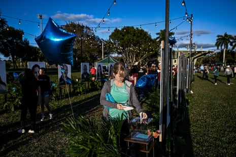 People visit a memorial for the victims of the Marjory Stoneman Douglas high school shooting on the fifth anniversary of the massacre in Parkland, Florida.