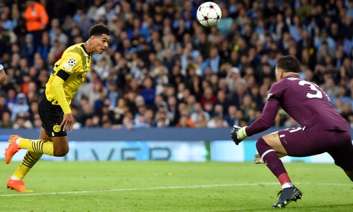 Dortmund's Judd Bellingham beats Manchester City goalkeeper Ederson to open the scoring.