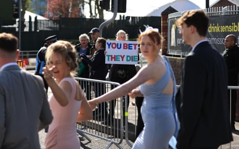 An animal rights protester holds up a placard near the entrance to the track.