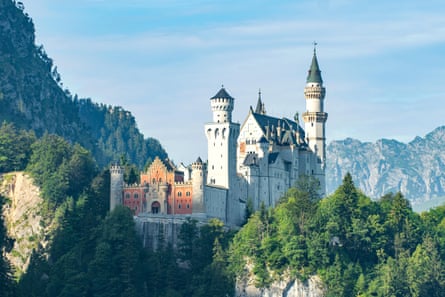 A turreted castle rising between mountains