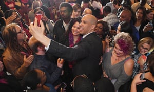 Booker takes photos after a campaign event in North Las Vegas.