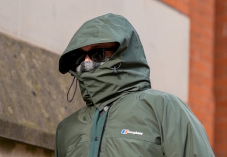 Jonathan Kirk wearing a green coat with the hood closed around his face