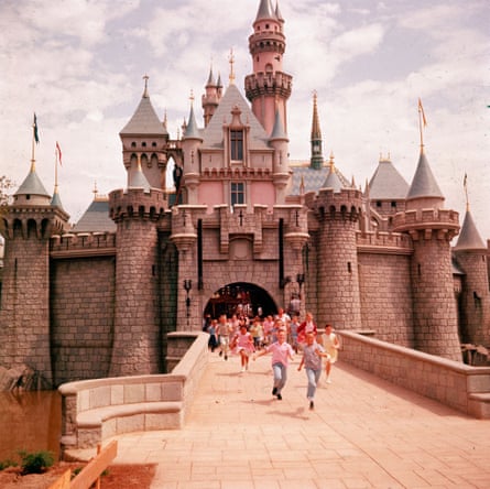 Children running through gate of Sleeping Beauty’s Castle at Walt Disney’s theme park, Disneyland.Sleeping Beauty’s Castle, Anaheim, California, USA, 1955