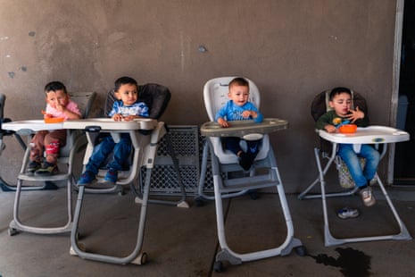 children eating in high chairs