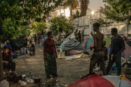 Refugees from sub-Saharan African countries gather outside the offices of the International organisation for Migration (OIM) in Tunis