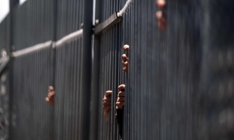detention essay titles The hands of immigration detainees holding bars