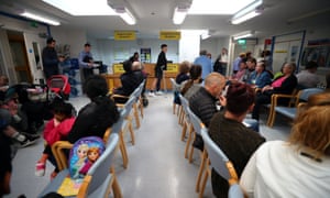 People wait in the waiting room at Milton Keynes University Hospital