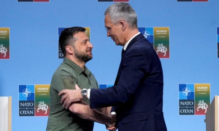 Ukraine’s president Volodymyr Zelenskiy and Nato secretary-general Jens Stoltenberg shake hands at a press conference during a Nato leaders summit in Vilnius, Lithuania, 12 July 2023.