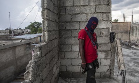 A gang member poses for a photo in the Portail Leogane neighborhood of Port-au-Prince, Haiti, in mid-September.