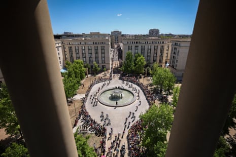 The peloton cycles across Place de Thessalie in central Montpellier.