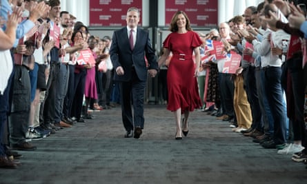 Keir Starmer and his wife Victoria walking down a row of Labour supporters