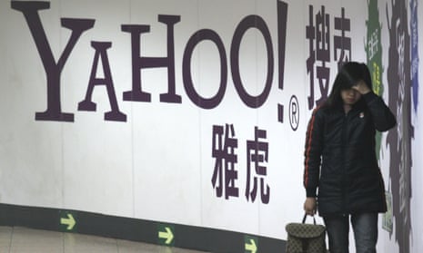 A woman walks past a Yahoo billboard in a Beijing subway in March 2006