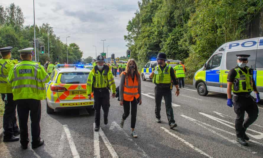 Police arrest a protester from Insulate Britain at the A41 roundabout at Junction 20 of the M25.