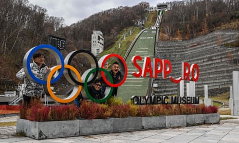 People pose for a picture with the Olympic signage at the Sapporo Olympic Museum