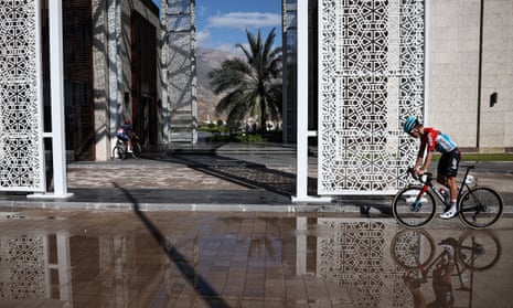 A cyclist rides over wet ground in Oman