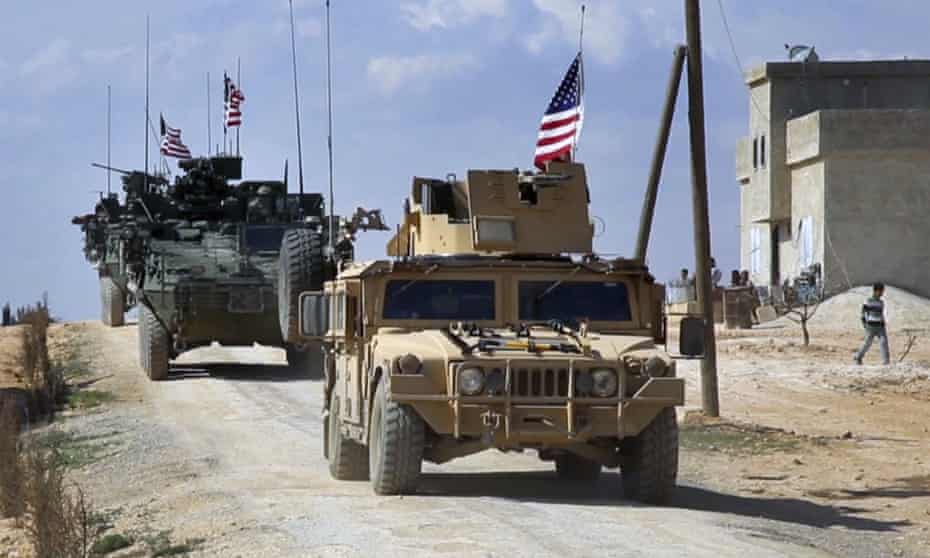 US forces patrol the outskirts of the Syrian town of Manbij.